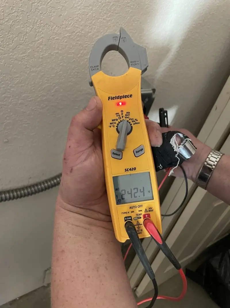 Voltage testing with clamp meter during Outlet Installation in Cleveland